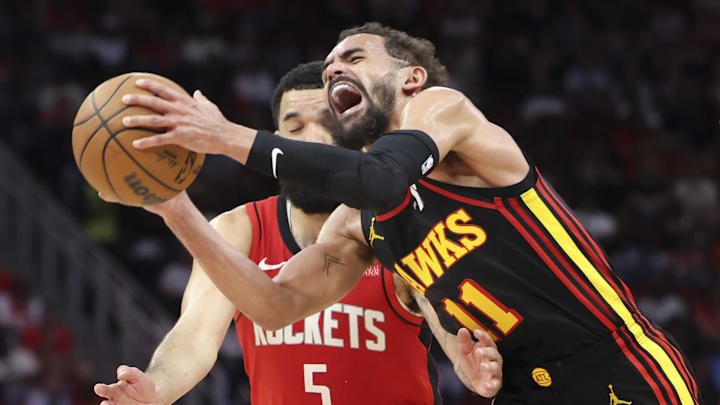 Trae Young (11) controls the ball as Fred VanVleet (5) defends during the third quarter at Toyota Center. 