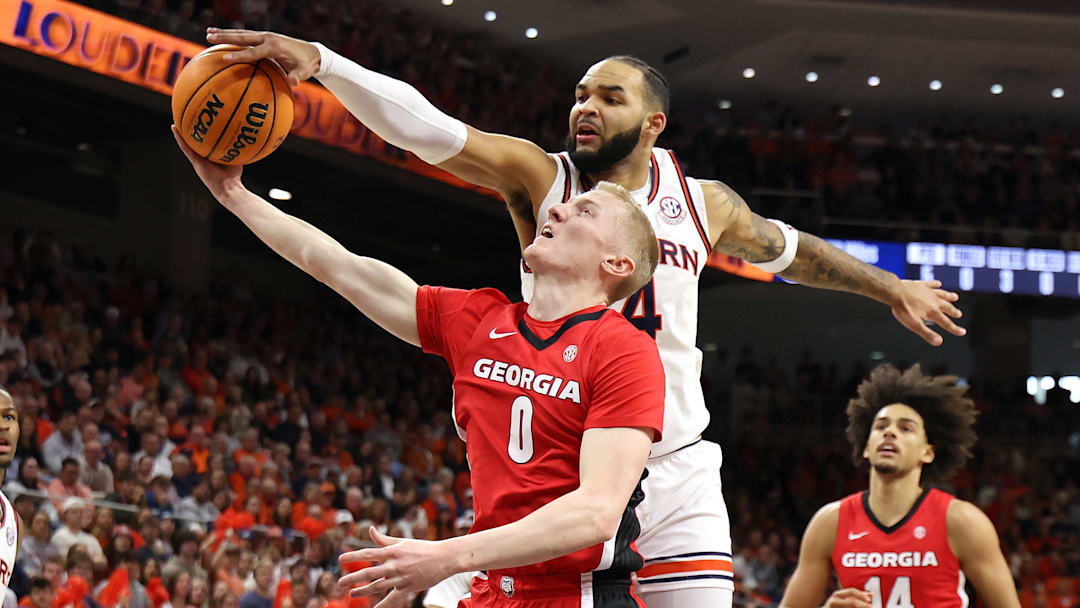 Feb 22, 2025; Auburn, Alabama, USA;  Auburn Tigers forward Johni Broome (4) blocks the shot of Georgia Bulldogs guard Blue Cain (0) during the first half at Neville Arena. Mandatory Credit: John Reed-Imagn Images
