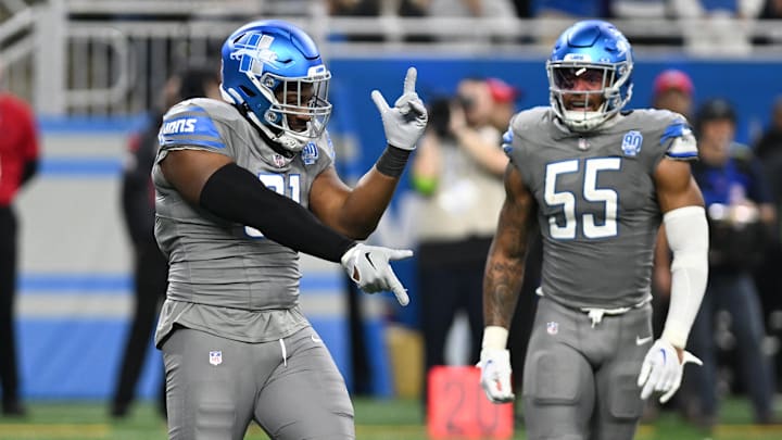 Detroit Lions defensive end Levi Onwuzurike (91) celebrates with  linebacker Derrick Barnes (55) 