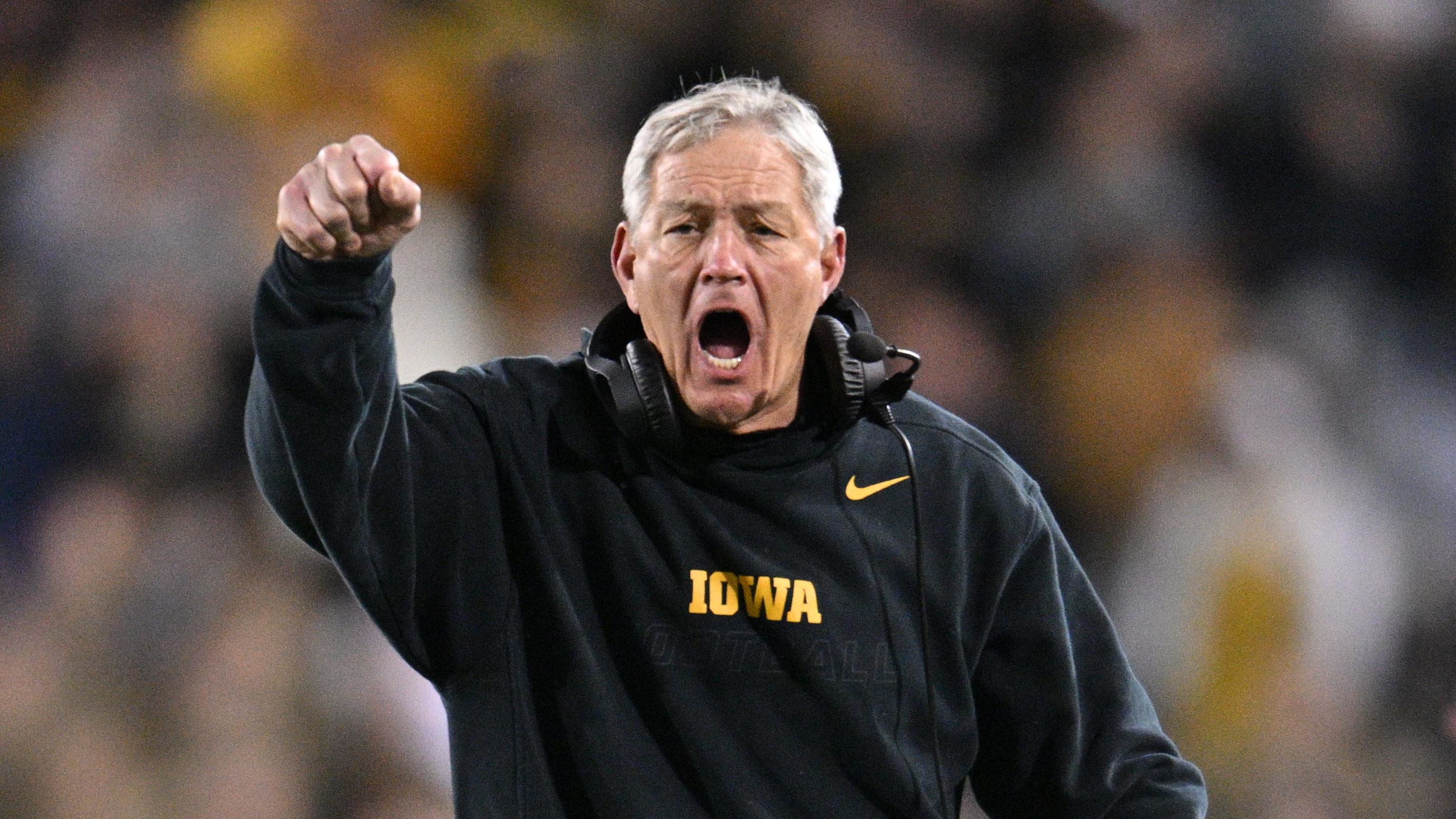 Iowa Hawkeyes head coach Kirk Ferentz coaching from the sideline during a college football game in the Big Ten.