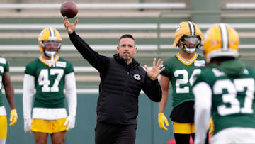 Green Bay Packers head coach Matt LaFleur throws the the ball to cornerback Johnathan Baldwin (37) during the team's first day of minicamp on June 10, 2025, at Ray Nitschke Field in Ashwaubenon, Wis.