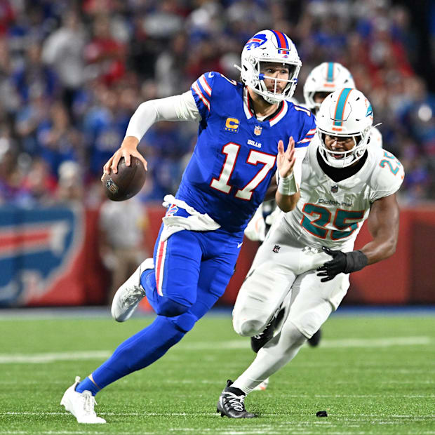 Buffalo Bills quarterback Josh Allen runs against Miami Dolphins LB Tyrel Dodson in the second half at Highmark Stadium.