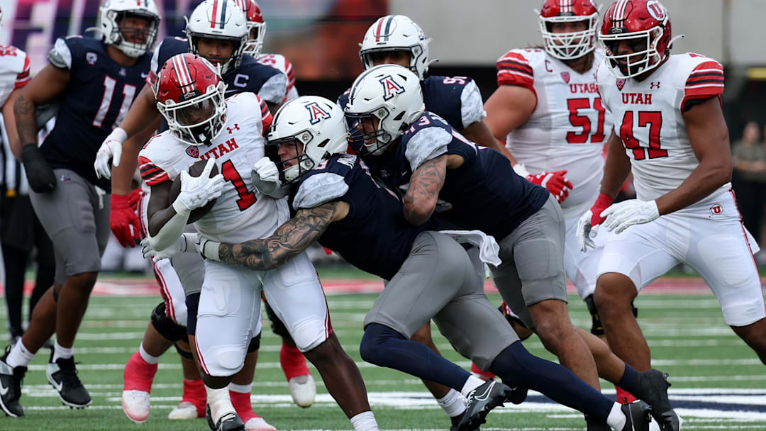 Nov 18, 2023; Tucson, Arizona, USA; Arizona Wildcats safety Gunner Maldonado (9) tackles Utah Utes running back Jaylon Glover (1) during the second half at Arizona Stadium. Mandatory Credit: Zachary BonDurant-Imagn Images