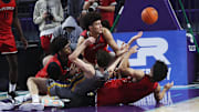 Players for the Miami Columbus High School basketball fight for the ball against Montverde during the championship game against at the City of Palms Classic at Suncoast Credit Union Arena in Fort Myers on Monday, Dec. 23, 2024.