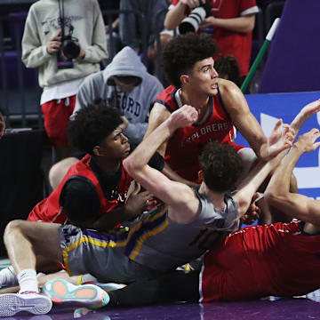 Players for the Miami Columbus High School basketball fight for the ball against Montverde during the championship game against at the City of Palms Classic at Suncoast Credit Union Arena in Fort Myers on Monday, Dec. 23, 2024.
