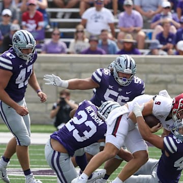 Sep 9, 2023; Manhattan, Kansas, USA; Troy Trojans quarterback Goose Crowder (9) is tackled by Kansas State Wildcats linebacker Austin Romaine (45), defensive tackle Damian Ilalio (56) and linebacker Asa Newsom (23) during the fourth quarter at Bill Snyder Family Football Stadium. Mandatory Credit: Scott Sewell-USA TODAY Sports