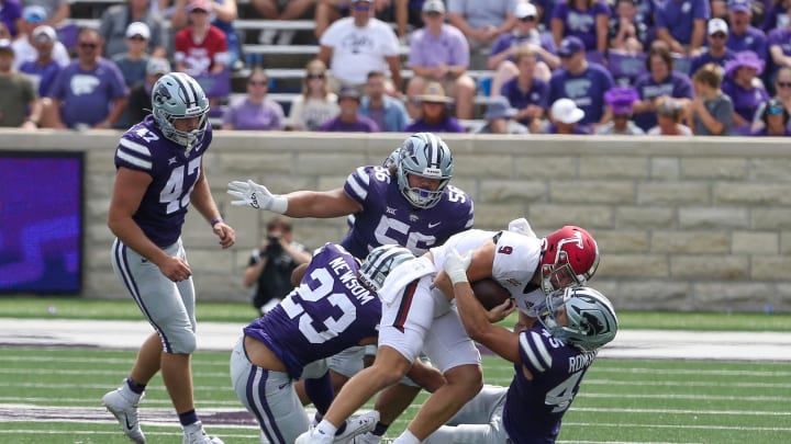 Sep 9, 2023; Manhattan, Kansas, USA; Troy Trojans quarterback Goose Crowder (9) is tackled by Kansas State Wildcats linebacker Austin Romaine (45), defensive tackle Damian Ilalio (56) and linebacker Asa Newsom (23) during the fourth quarter at Bill Snyder Family Football Stadium. Mandatory Credit: Scott Sewell-USA TODAY Sports