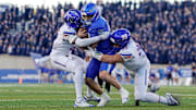 Air Force quarterback Liam Szarka is sacked by Boise State's Jeremiah Earby (6) and Max Stege.