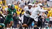 Nov 1, 2025; Waco, Texas, USA; UCF Knights quarterback Tayven Jackson (2) scrambles with the ball as Baylor Bears linebacker Keaton Thomas (11) defends during the second half at McLane Stadium. Mandatory Credit: Raymond Carlin III-Imagn Images