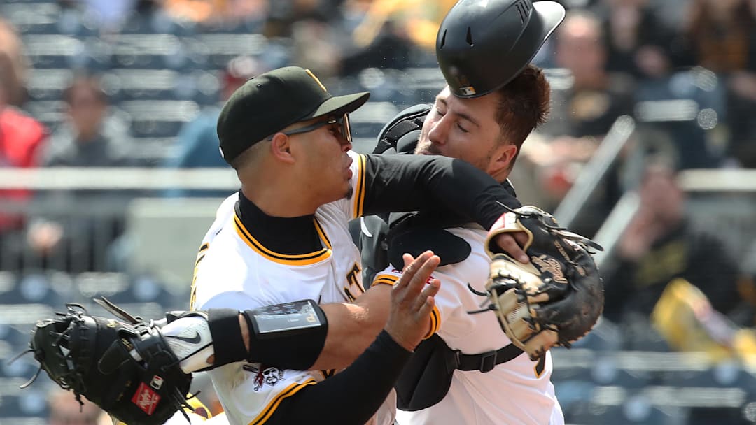 Apr 9, 2025; Pittsburgh, Pennsylvania, USA;  Pittsburgh Pirates first baseman Endy Rodriguez (5) and catcher Joey Bart (14) collide attempting to catch a pop-up hit by St. Louis Cardinals designated hitter Willson Contreras (not pictured) during the eighth inning at PNC Park. Mandatory Credit: Charles LeClaire-Imagn Images