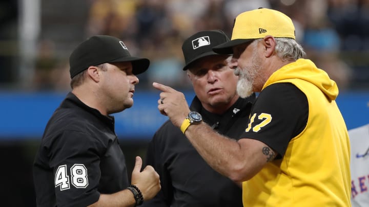 Pittsburgh Pirates manager Derek Shelton (17) argues with umpires Nick Mahrley (48) and Nick Mahrley (middle) against the New York Mets during the seventh inning at PNC Park.