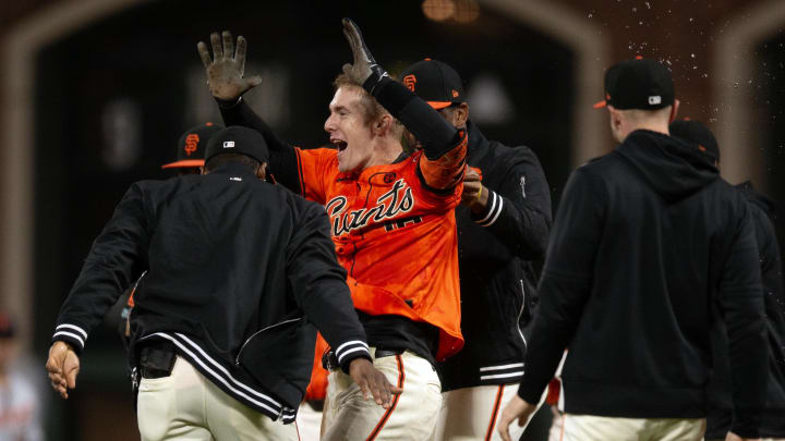 Aug 9, 2024; San Francisco, California, USA; San Francisco Giants designated hitter Mark Canha is mobbed by his teammates.