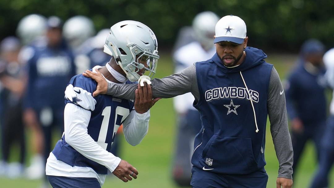 May 1, 2026; Frisco, TX, USA;  Dallas Cowboys cornerback Caleb Downs (18) is coached through a drill with defensive coordinator Christian Parker at the Ford Center at the Star Training Facility in Frisco, Texas.  Mandatory Credit: Chris Jones-Imagn Images