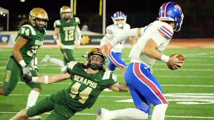 St. Bonaventure High safety Dylan Dunst reaches for Folsom High quarterback Ryder Lyons during the CIF-State Division 1-A state championship bowl at Saddleback College in Mission Viejo on Saturday, Dec. 9, 2023. The Seraphs lost 20-14.