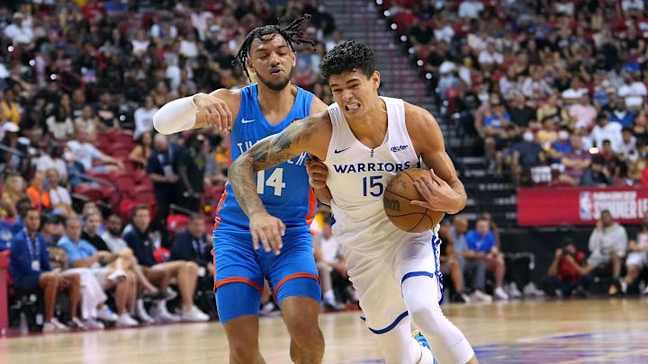 Jul 15, 2022; Las Vegas, NV, USA; Golden State Warriors forward Gui Santos (15) dribbles past Oklahoma City Thunder guard Jaden Shackelford (14) during an NBA Summer League game at Thomas & Mack Center. Mandatory Credit: Stephen R. Sylvanie-Imagn Images