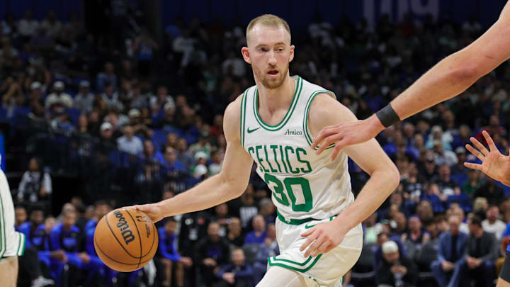 Boston Celtics forward Sam Hauser dribbles the ball.