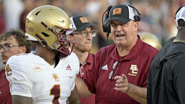 Boston College Eagles quarterback Thomas Castellanos speaks with head coach Bill O'Brien before a game against Florida State.