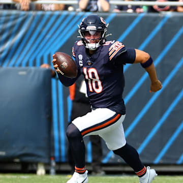 Sep 8, 2024; Chicago, Illinois, USA; Chicago Bears quarterback Caleb Williams (18) rushes the ball against the Tennessee Titans during the second quarter at Soldier Field. Mandatory Credit: Mike Dinovo-Imagn Images