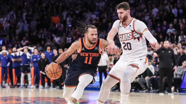 Nov 26, 2023; New York, New York, USA; New York Knicks guard Jalen Brunson (11) drives past Phoenix Suns center Jusuf Nurkic (20) in the fourth quarter at Madison Square Garden. Mandatory Credit: Wendell Cruz-USA TODAY Sports