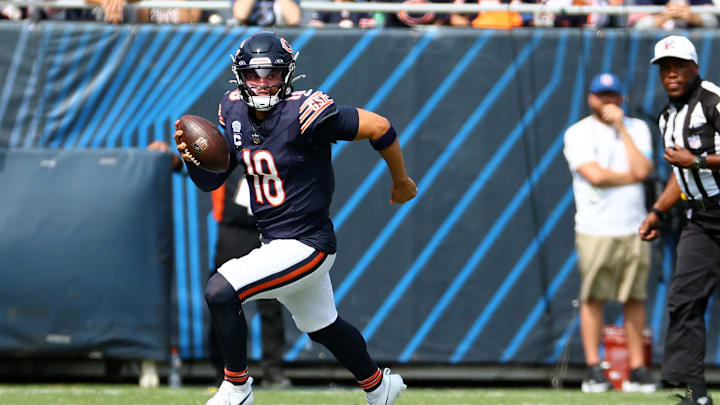 Sep 8, 2024; Chicago, Illinois, USA; Chicago Bears quarterback Caleb Williams (18) rushes the ball against the Tennessee Titans during the second quarter at Soldier Field. Mandatory Credit: Mike Dinovo-Imagn Images