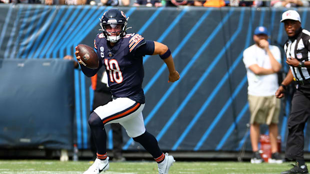 Chicago Bears quarterback Caleb Williams (18) rushes the ball against the Tennessee Titans