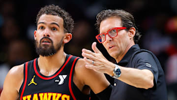 Trae Young #11 and head coach Quin Snyder of the Atlanta Hawks talk during a break in action against the Sacramento Kings.