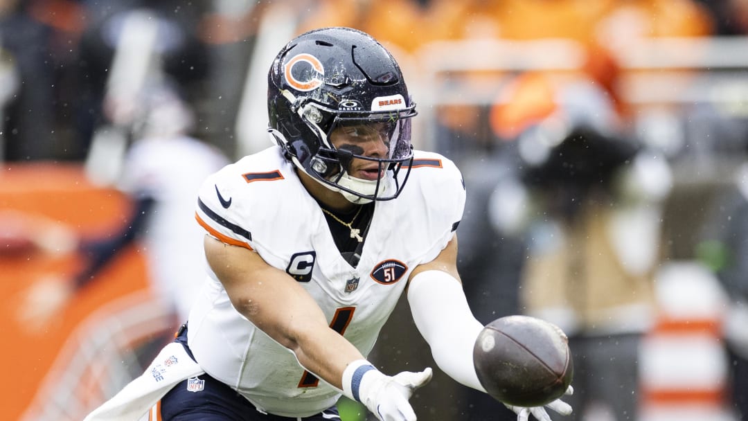 Dec 17, 2023; Cleveland, Ohio, USA; Chicago Bears quarterback Justin Fields (1) pitches the ball to a running back against the Cleveland Browns during the first quarter at Cleveland Browns Stadium. Mandatory Credit: Scott Galvin-USA TODAY Sports