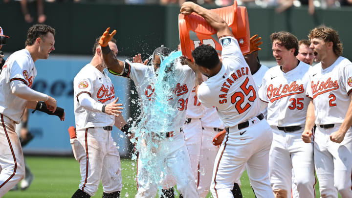 Jul 14, 2024; Baltimore, Maryland, USA;  Baltimore Orioles outfielder Cedric Mullins (31), Anthony Santander (25) and teammates celebrate a walk-off win against the New York Yankees at Oriole Park at Camden Yards. 