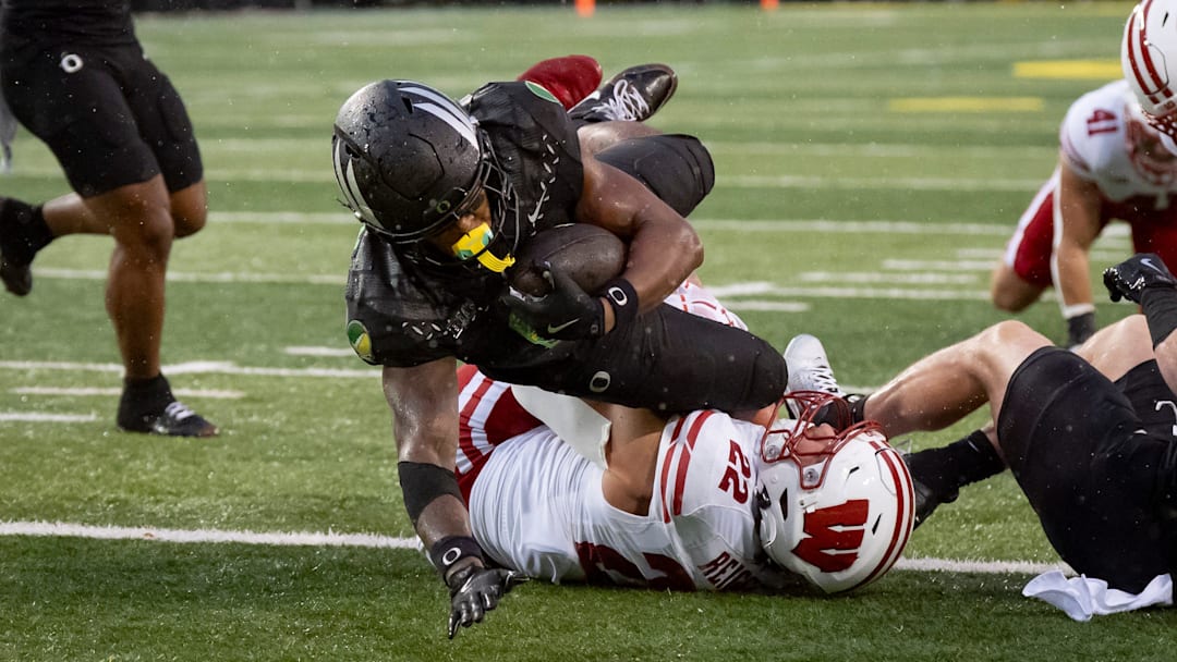 Oregon running back Jordon Davison dives over Wisconsin linebacker Mason Reiger for a touchdown as the Oregon Ducks host the Wisconsin Badgers on Oct. 25, 2025, at Autzen Stadium in Eugene, Oregon.
