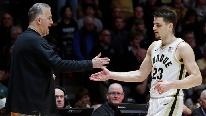 Purdue Boilermakers head coach Matt Painter high-fives Camden Heide 