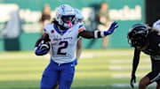 Oct 12, 2024; Honolulu, Hawaii, USA;  Boise State Broncos running back Ashton Jeanty (2) stiff arms Hawaii Rainbow Warriors defensive back Kilinahe Mendiola-Jensen (29) for a touchdown during the first quarter an NCAA college football game at Clarence T.C. Ching Athletics Complex. Mandatory Credit: Marco Garcia-Imagn Images