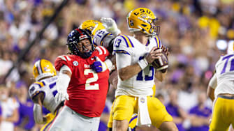Oct 12, 2024; Baton Rouge, Louisiana, USA;  Mississippi Rebels defensive tackle Walter Nolen (2) reaches to knock the ball loose from LSU Tigers quarterback Garrett Nussmeier (13) during the first half at Tiger Stadium. Mandatory Credit: Stephen Lew-Imagn Images