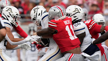 Aug 31, 2024; Columbus, OH, USA; Ohio State Buckeyes linebacker C.J. Hicks (11) sacks Akron Zips quarterback Ben Finley (10) during the first half of the NCAA football game at Ohio Stadium.