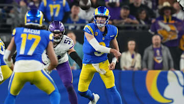Los Angeles Rams quarterback Matthew Stafford (9) throws the ball to receiver Puka Nacua (17) against the Minnesota Vikings during their playoff game at State Farm Stadium on Jan. 13, 2025, in Glendale.