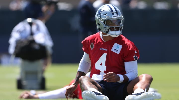 Jul 26, 2024; Oxnard, CA, USA; Dallas Cowboys quarterback Dak Prescott (4) stretches during training camp at the River Ridge Playing Fields in Oxnard, Californian.  Mandatory Credit: Jason Parkhurst-USA TODAY Sports