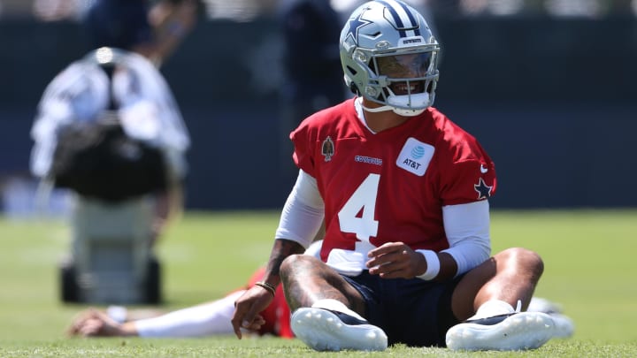 Jul 26, 2024; Oxnard, CA, USA; Dallas Cowboys quarterback Dak Prescott (4) stretches during training camp at the River Ridge Playing Fields in Oxnard, California.