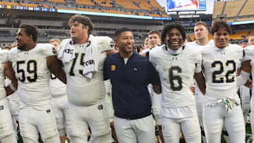 Nov 15, 2025; Pittsburgh, Pennsylvania, USA;  Notre Dame Fighting Irish head coach Marcus Freeman (middle) joins his players in singing the victory song after defeating the Pittsburgh Panthers at Acrisure Stadium. 