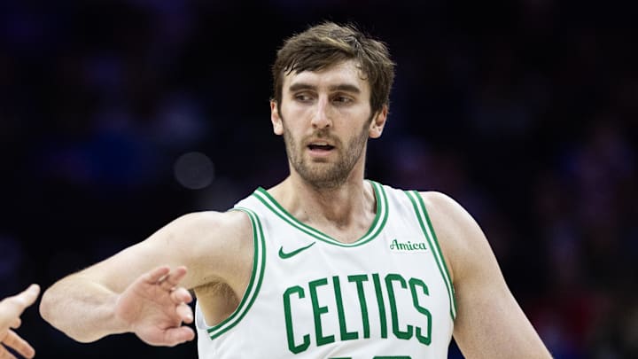 Boston Celtics center Luke Kornet high fives a teammate.