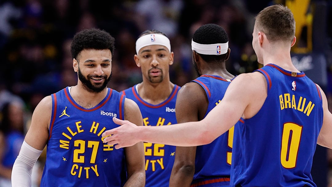 Mar 9, 2024; Denver, Colorado, USA; Denver Nuggets guard Jamal Murray (27) reacts with forward Justin Holiday (9) and guard Christian Braun (0) and forward Zeke Nnaji (22) in the first quarter at Ball Arena.