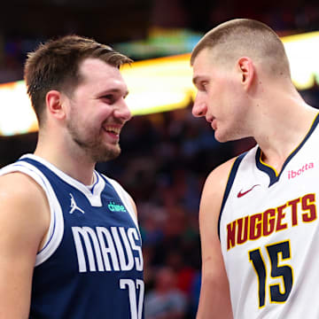 Mar 17, 2024; Dallas, Texas, USA;  Dallas Mavericks guard Luka Doncic (77) speaks with Denver Nuggets center Nikola Jokic (15) during the second half at American Airlines Center. 