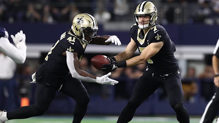 Nov 29, 2018; Arlington, TX, USA; New Orleans Saints quarterback Taysom Hill (7) hands off the ball to running back Alvin Kamara (41) against the Dallas Cowboys at AT&T Stadium. Mandatory Credit: Matthew Emmons-Imagn Images