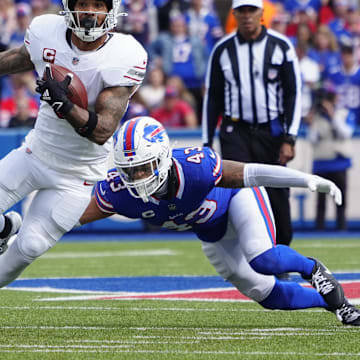 Sep 8, 2024; Orchard Park, New York, USA; Arizona Cardinals running back James Conner (6) runs with the ball past Buffalo Bills linebacker Terrel Bernard (43) during the second half at Highmark Stadium. 