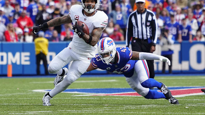 Sep 8, 2024; Orchard Park, New York, USA; Arizona Cardinals running back James Conner (6) runs with the ball past Buffalo Bills linebacker Terrel Bernard (43) during the second half at Highmark Stadium. 