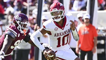 Arkansas Razorbacks quarterback Taylen Green (10) runs the ball while defended by Mississippi State Bulldogs defensive lineman Deonte Anderson (91) during the second quarter at Davis Wade Stadium at Scott Field during 2024 season.