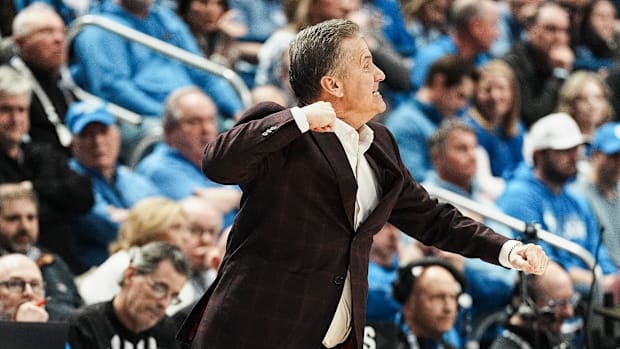 Arkansas coach and former UK coach John Calipari pumps his fist in excitement as the Hogs secure an 89-79 win 