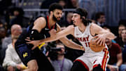 Feb 29, 2024; Denver, Colorado, USA; Miami Heat guard Jaime Jaquez Jr. (11) controls the ball as Denver Nuggets guard Jamal Murray (27) guards in the second quarter at Ball Arena. Mandatory Credit: Isaiah J. Downing-Imagn Images
