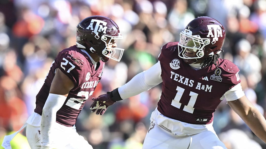 Dec 20, 2025; College Station, TX, USA; Texas A&M Aggies linebacker Daymion Sanford (27) reacts with defensive tackle Tyler Onyedim (11) after recovering a fumble against the Miami Hurricanes during the second half of the first round game of the CFP National Playoff at Kyle Field. Mandatory Credit: Maria Lysaker-Imagn Images