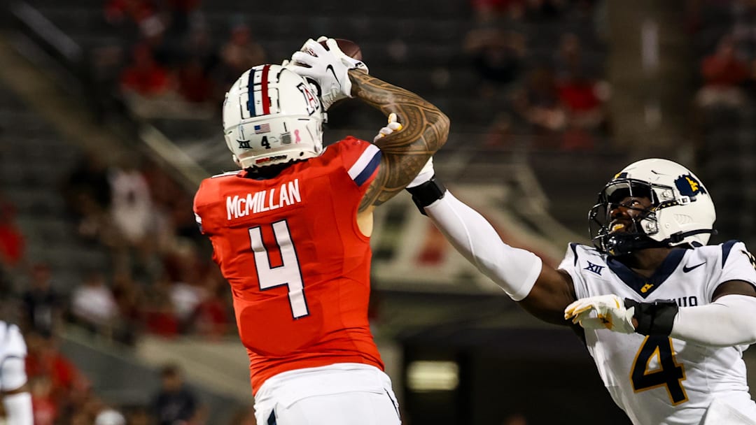 Oct 26, 2024; Tucson, Arizona, USA; Arizona Wildcats wide receiver Tetairoa McMillan (4) catches a long pass while West Virginia Mountaineers linebacker Trey Lathan (4) fails to defend against him during the fourth quarter at Arizona Stadium. Mandatory Credit: Aryanna Frank-Imagn Images
