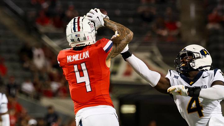 Oct 26, 2024; Tucson, Arizona, USA; Arizona Wildcats wide receiver Tetairoa McMillan (4) catches a long pass while West Virginia Mountaineers linebacker Trey Lathan (4) fails to defend against him during the fourth quarter at Arizona Stadium. Mandatory Credit: Aryanna Frank-Imagn Images