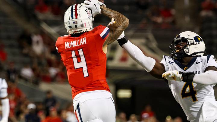 Oct 26, 2024; Tucson, Arizona, USA; Arizona Wildcats wide receiver Tetairoa McMillan (4) catches a long pass while West Virginia Mountaineers linebacker Trey Lathan (4) fails to defend against him during the fourth quarter at Arizona Stadium. Mandatory Credit: Aryanna Frank-Imagn Images